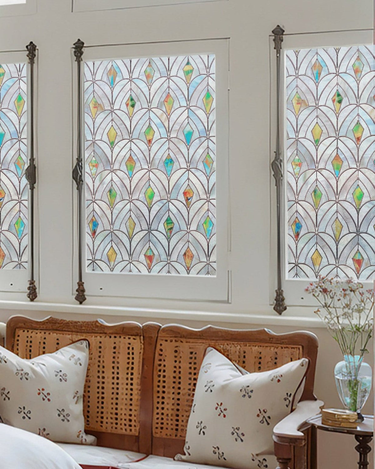 Peacocks film in bedroom windows above a woven headboard