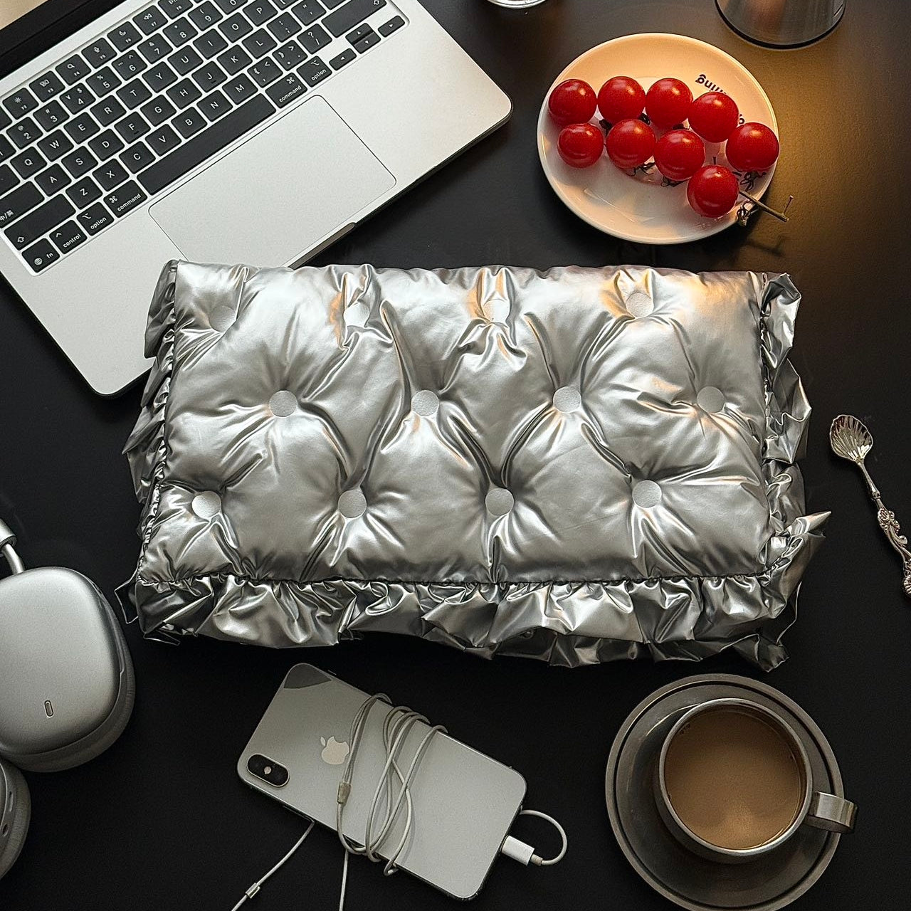 Silver Ruffle Graphene Hand Warmer | Portable USB Heating Bag on a modern desk setup with a laptop, coffee cup, and smartphone, featuring a quilted metallic silver design, ideal for office use, travel, and everyday portable warmth.