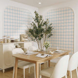Realistic 6ft Faux Olive Tree displayed in bright modern dining room interior with wooden table, white upholstered chairs, and arched grid wall panels | Artificial Potted Olive Plant for Home & Office Decor
