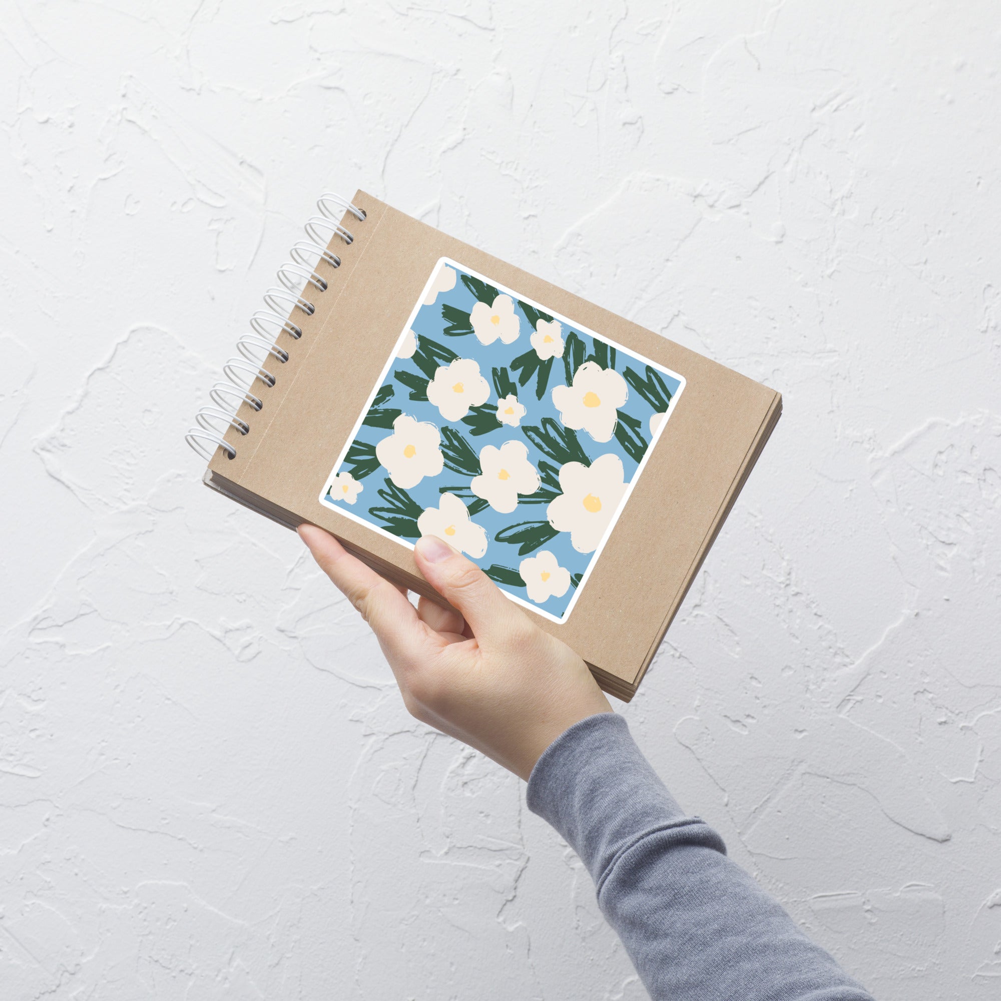 Artistic Blue Sticker with White Flowers – Hand-Drawn Floral Decal for Crafts on notebook