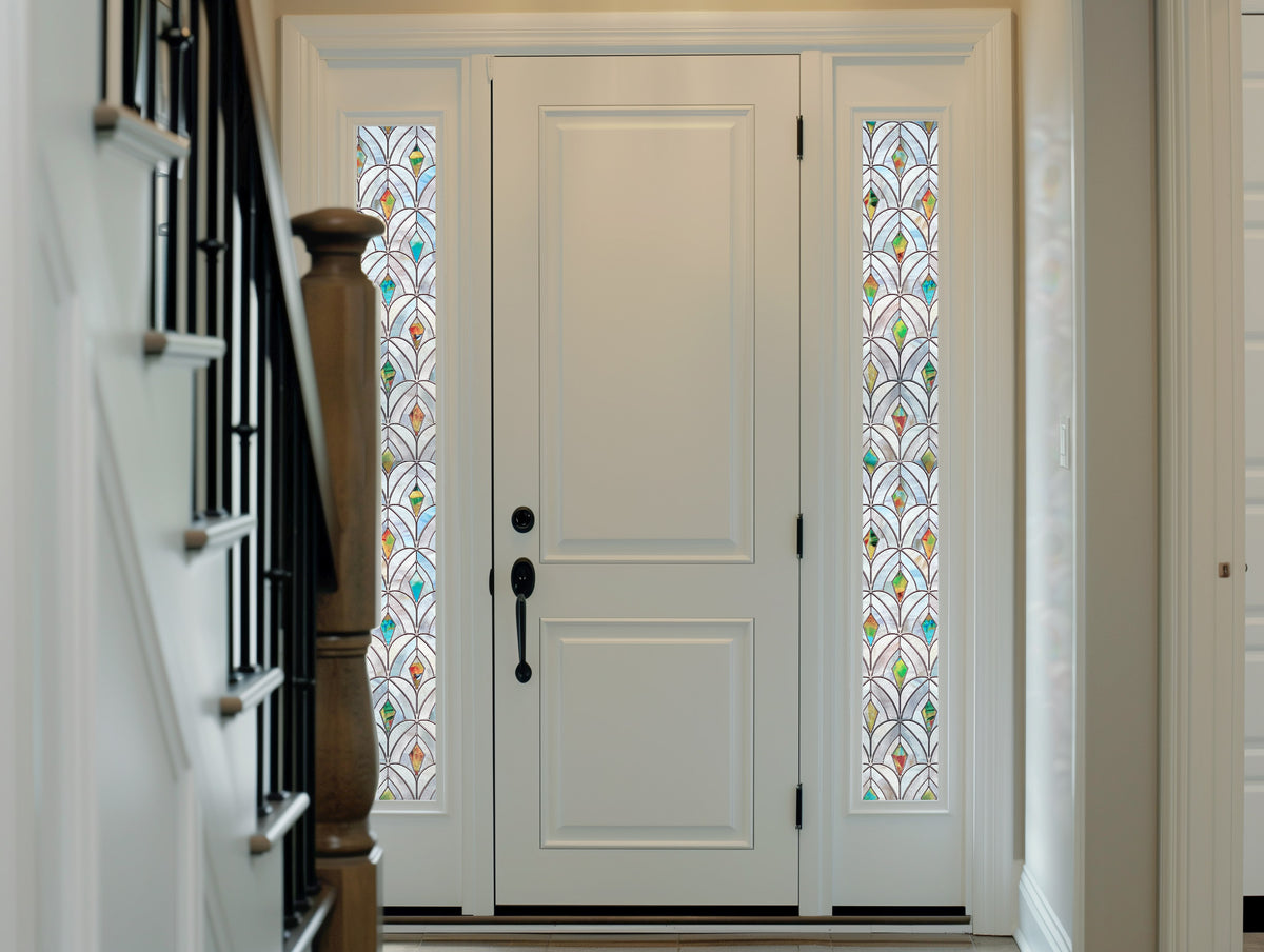 Narrow glass panels beside an interior door with Peacocks film